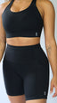 black supportive sports bra and running bike shorts with pockets