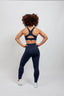 sustainable navy performance leggings with pockets and high support running bra 