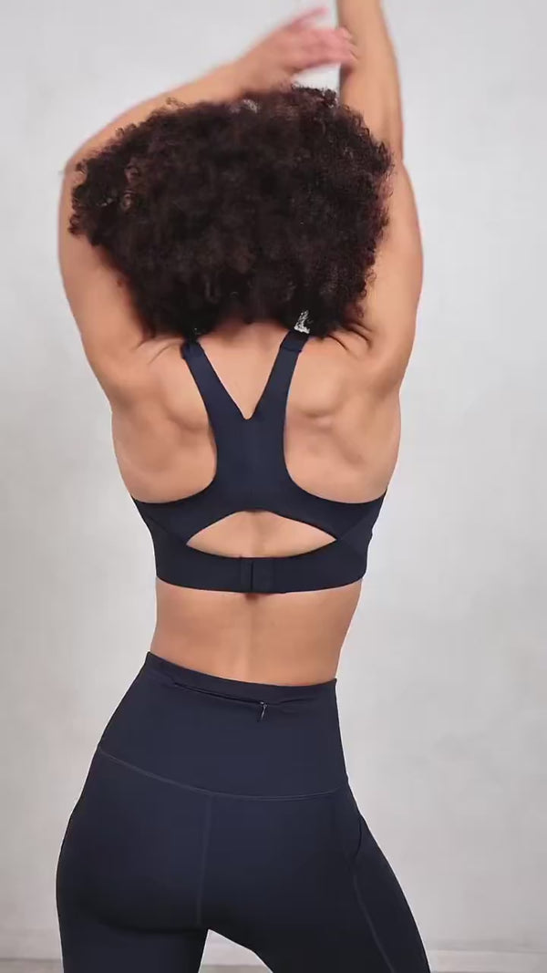 navy blue women's sportswear performance leggings and high support sports bra